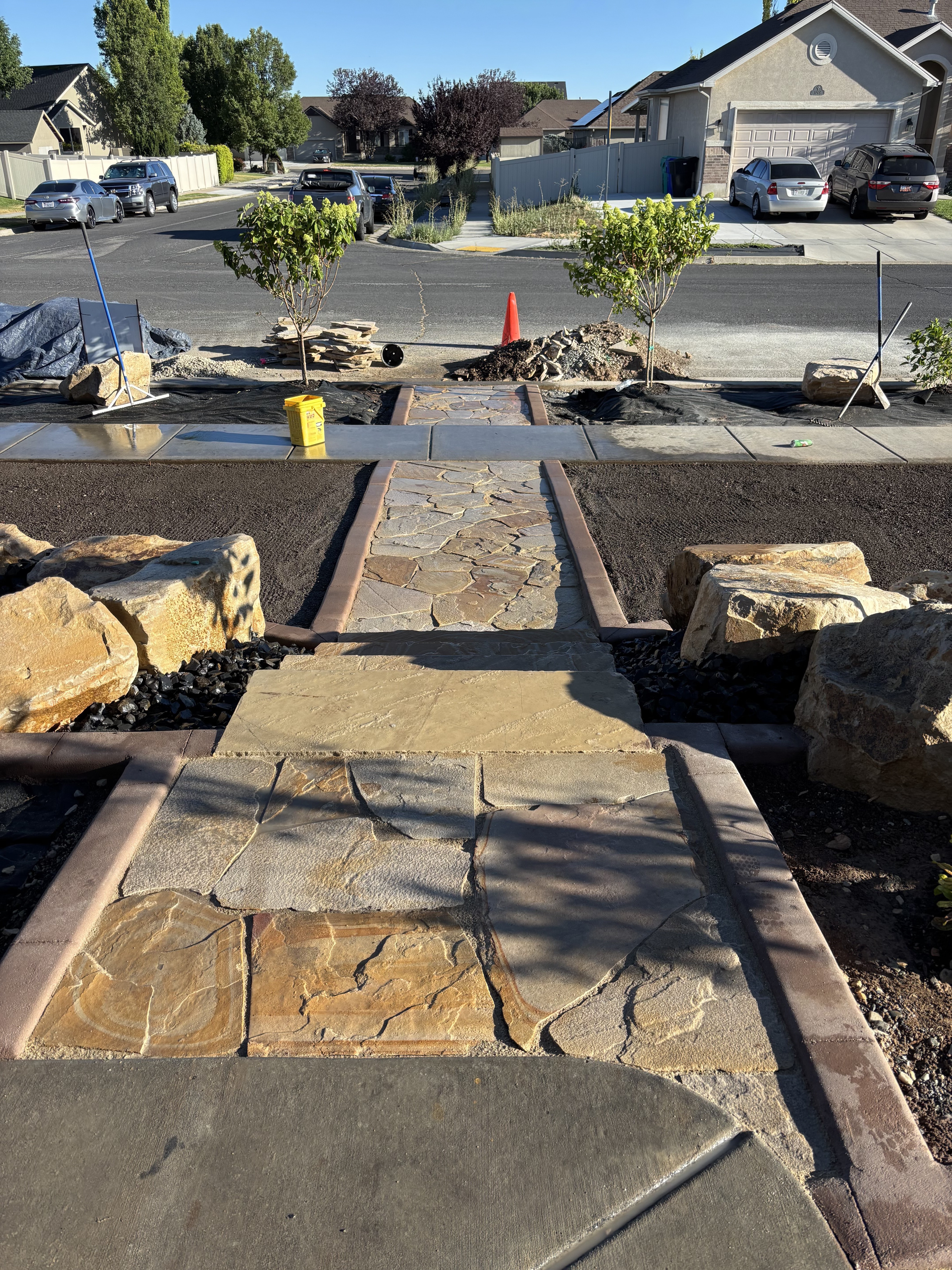 Natural flagstone walkway install with paver border banding