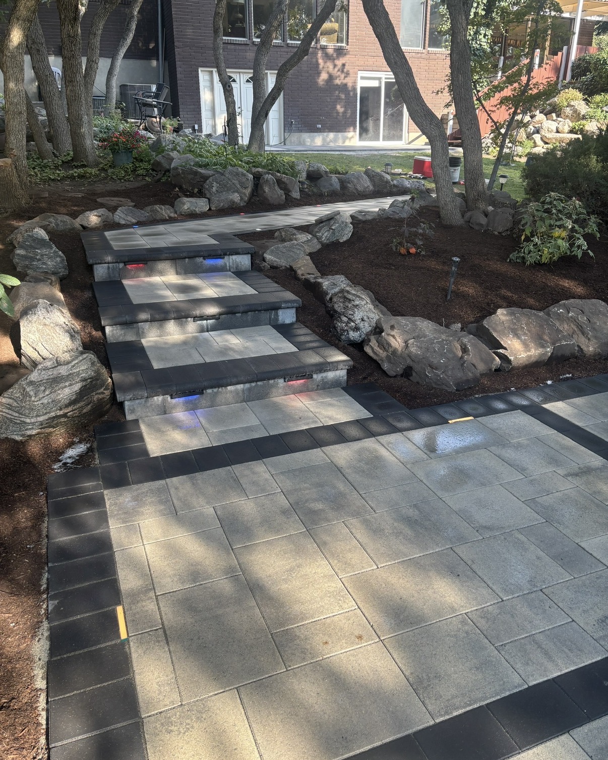 Multi level paver patio with stair detail and integrated lighting