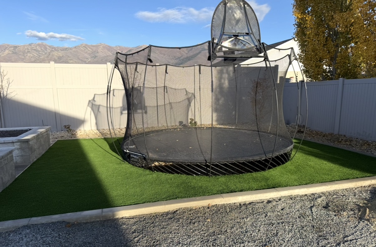 Sunken trampoline installed in synthetic turf field