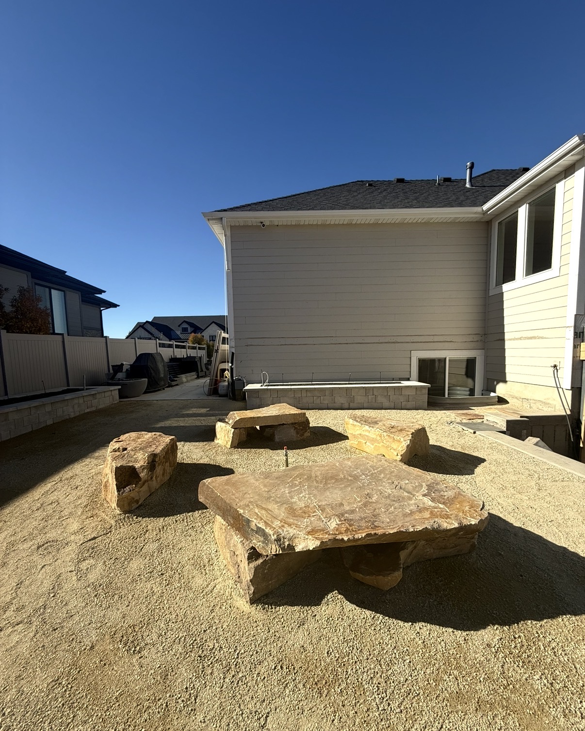 Boulder fire pit gathering area on gravel pad