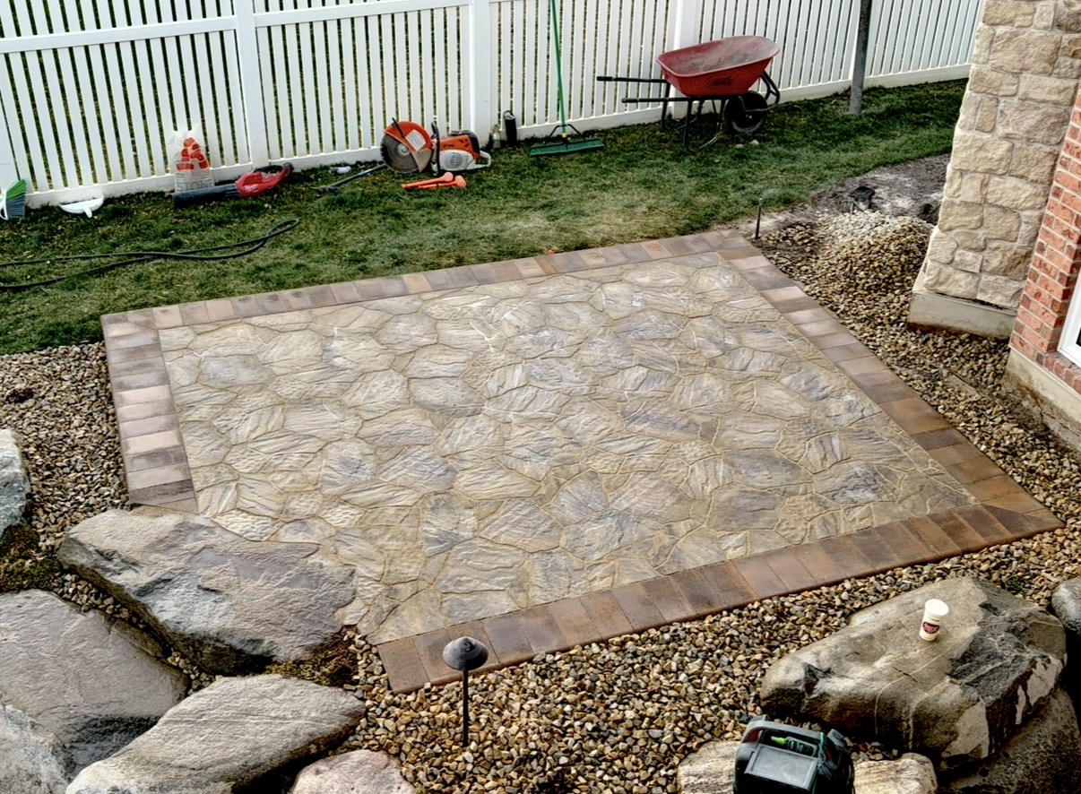 Stamped flagstone patio with brick paver border