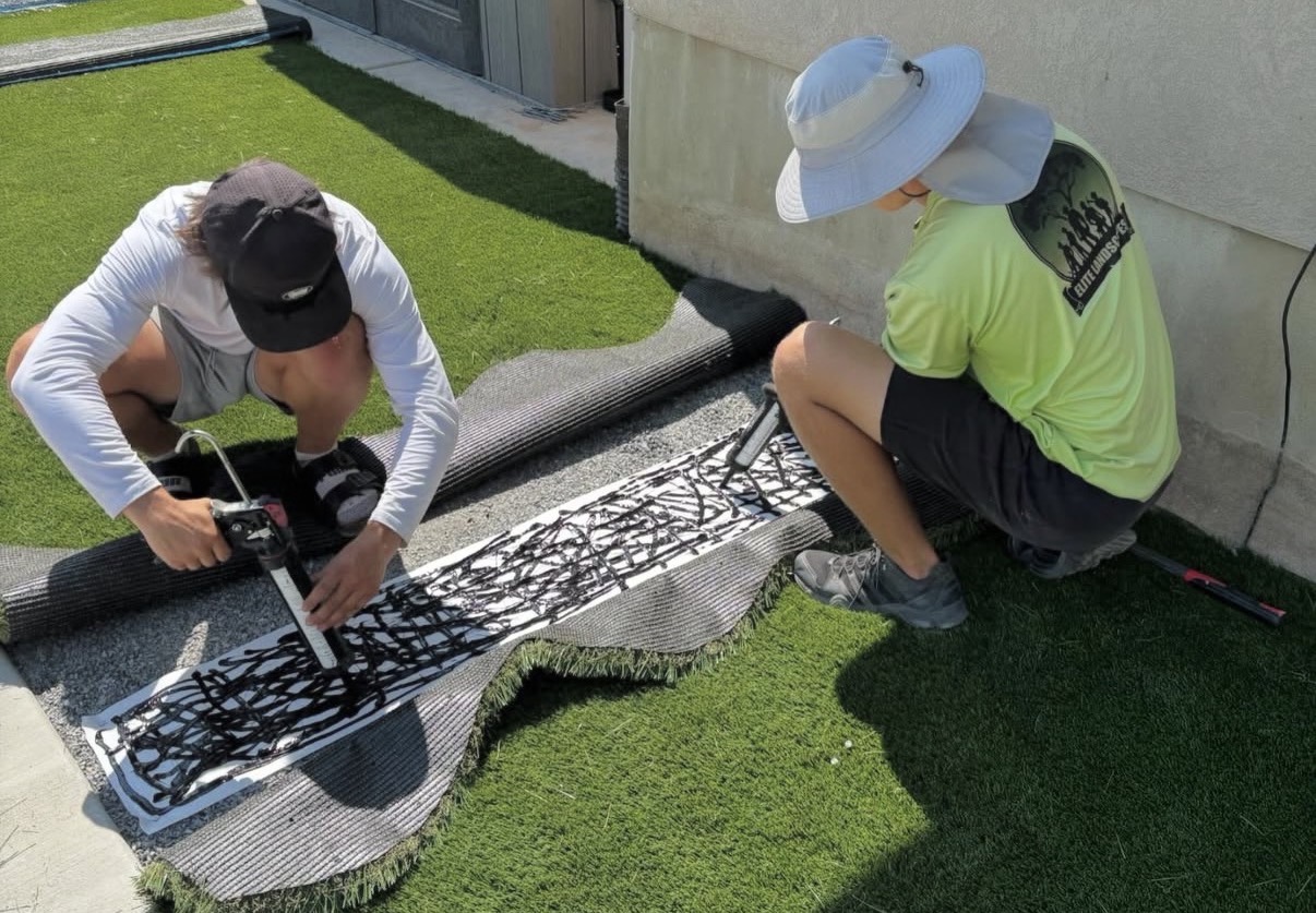 Elite Landscapes crew installing synthetic turf
