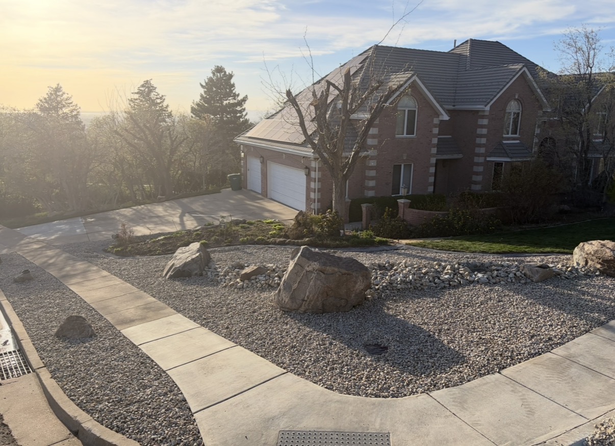 Estate front yard with boulder garden and rock at golden hour