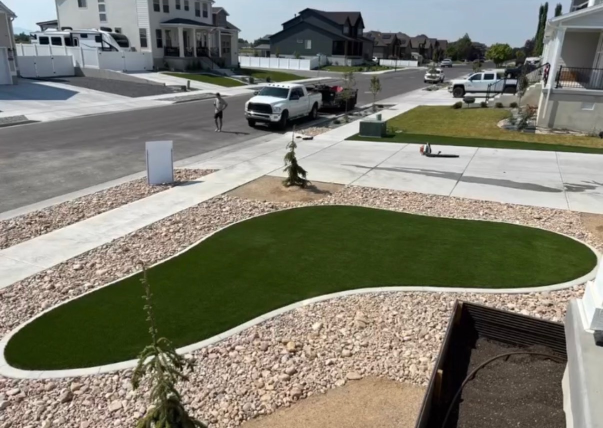 Front yard turf island with curved rock beds and sidewalk